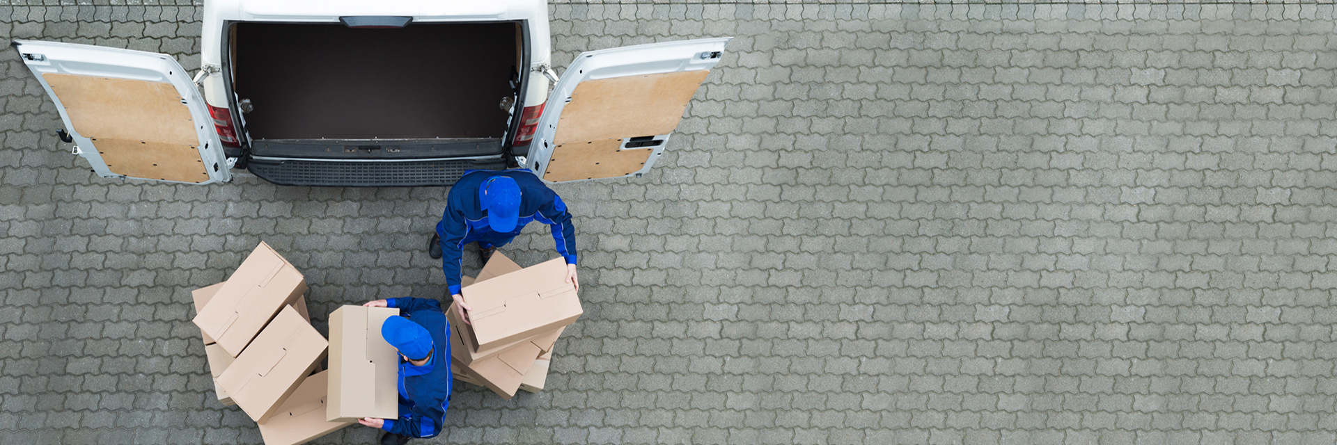 overhead view of two associates unloading boxes from white van